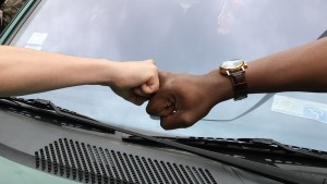 fist bump between two races to represent allyship